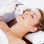 beautiful woman having botox injection in her lips